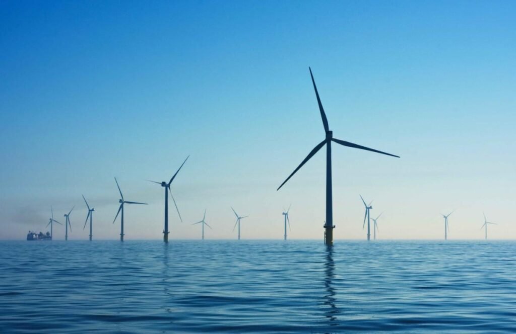 Suzlon Share News Today visual showing wind turbines and rising stock chart after 381 MW order